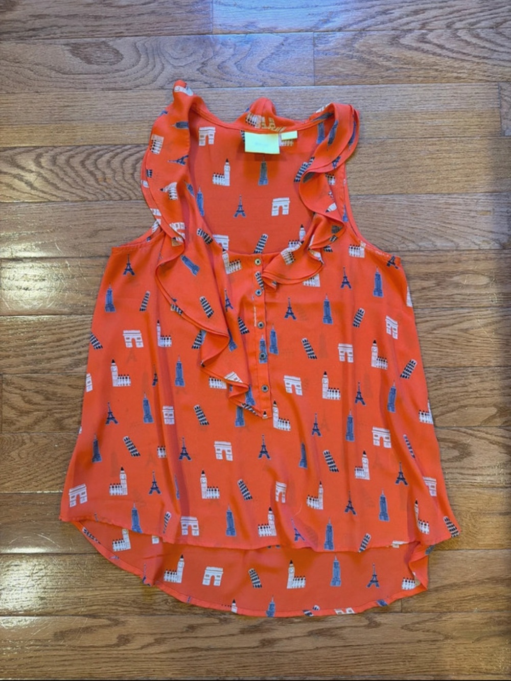Maeve Red-Orange Ruffle Sleeveless Blouse with Blue & White Landmark Print